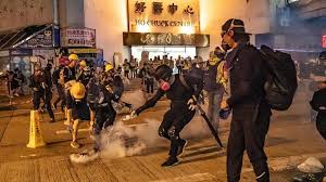 Clashes in Hong Kong as police fire tear gas into rail station