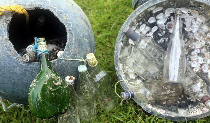 সৈকতজুড়ে ছড়িয়ে আছে বিদেশি মদের বোতল