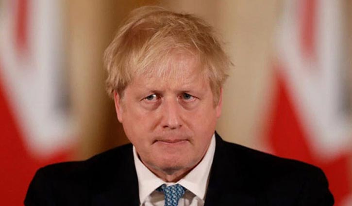 Boris Johnson sitting up on bed